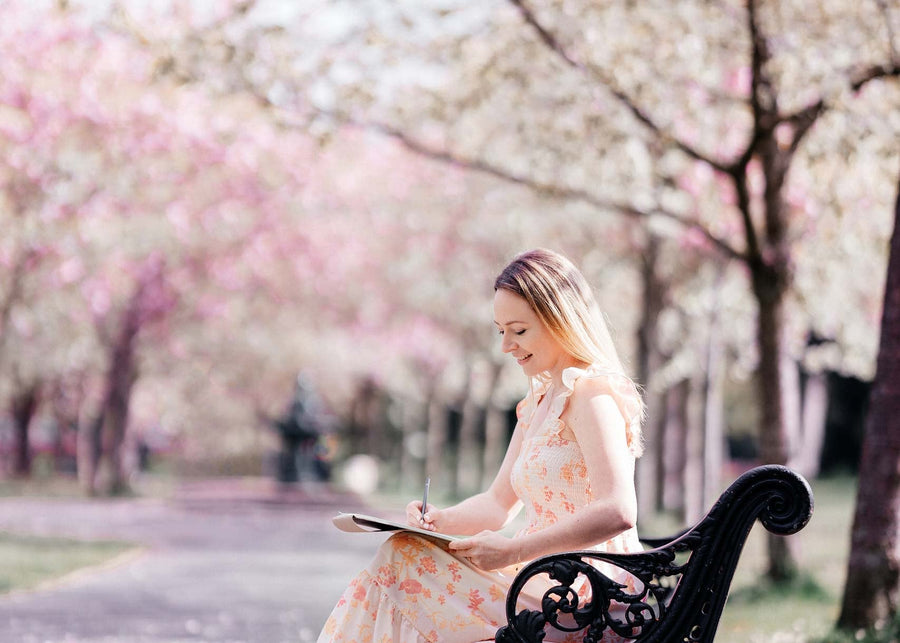 Janina sketching a new design on a park bench