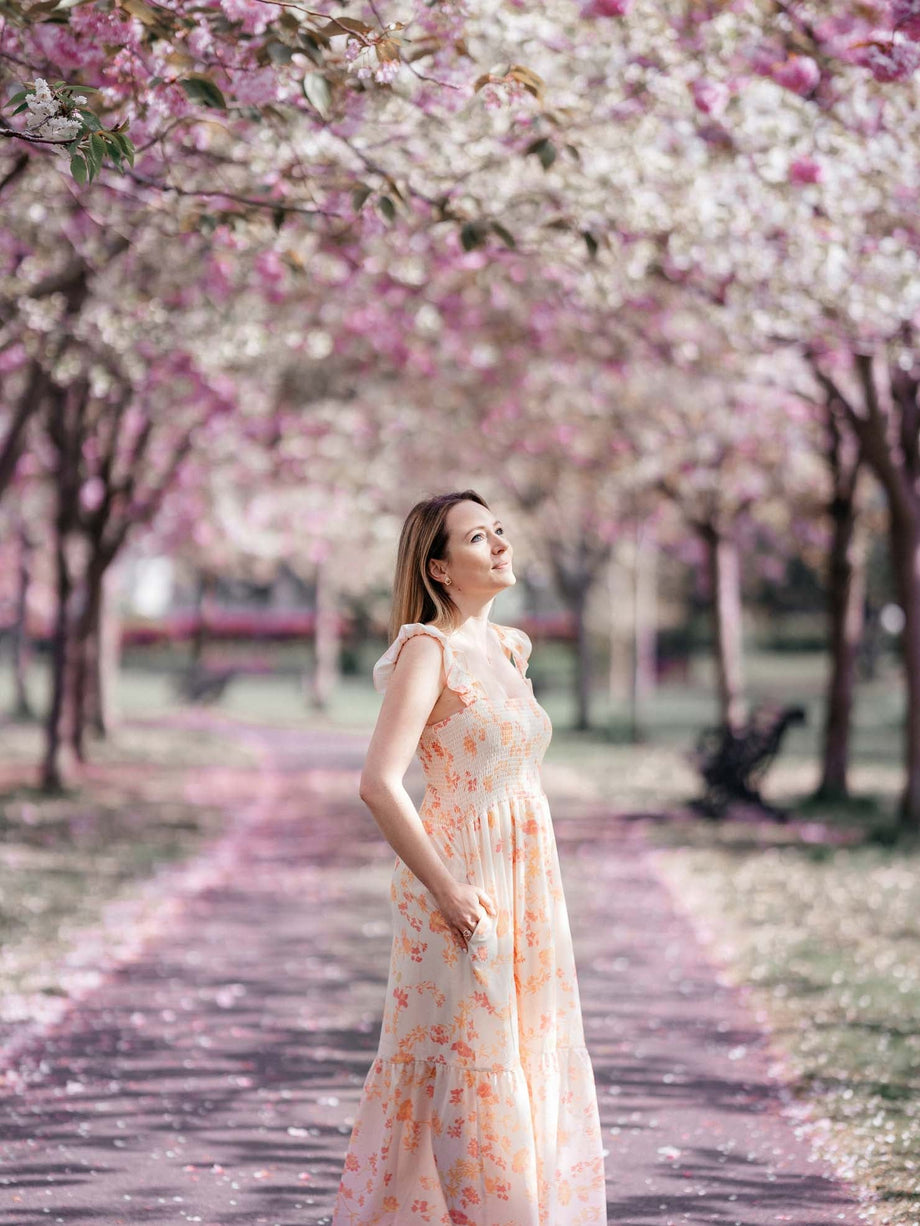 Janina, founder and designer of Riør Design, under blossoming cherry trees